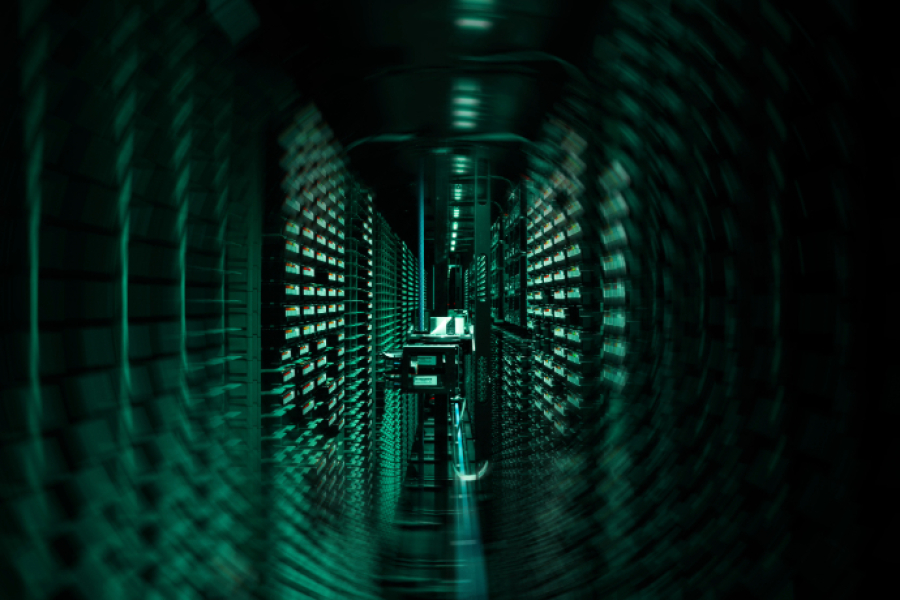 Photo of ECMWF's HPC illuminated green. The image is slightly swirled